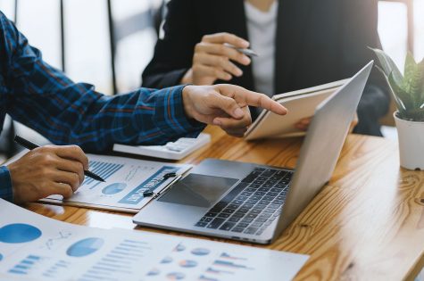 Business people discuss investment project working and planning strategy on laptop computer.